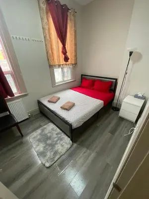 a bedroom with a bed with red pillows and a window at Central Downtown New Year Stay- Self Checkin & Free Wifi in Toronto