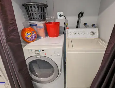 a washing machine sitting next to a washer at Room Ideal for Knowledge Workers in Toronto