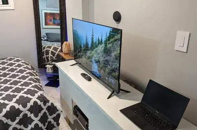 a computer monitor on a desk with a laptop at Room Ideal for Knowledge Workers in Toronto