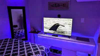 a bedroom with a purple room with a tv and a bed at Room Ideal for Knowledge Workers in Toronto