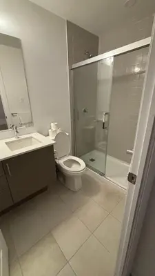 a bathroom with a shower and a toilet and a sink at Trafalgar in Oakville