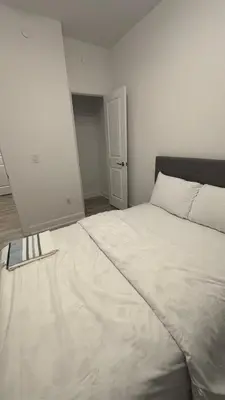 a bedroom with a large white bed in it at Trafalgar in Oakville