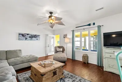 a living room with a couch and a ceiling fan at Crystal Beach Stunning Waterfront Stay with Fire Pit in Fort Erie