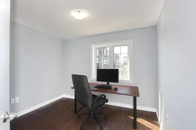 a computer sitting on a desk in a room with a window at Cozy 3 Bed Whole Rental Home for your stay! in Brampton