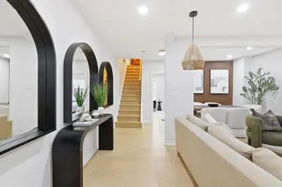 a living room with white walls and white furniture at Modern Queen West Retreat Massive Patio 65 TV in Toronto