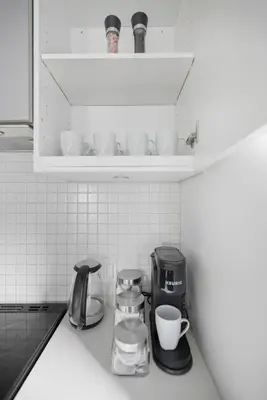 a kitchen counter top with a coffee maker and cups at Modern Downtown Retreat 3BR Condo with Patio in Toronto