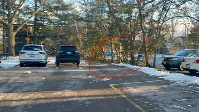 a red hose on the side of a road with cars at Luxurious Two Bedroom Apartment in Burlington