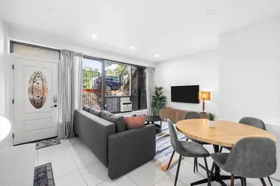 a living room with a couch and a table at Stylish 2BR Retreat by Queen West in Toronto