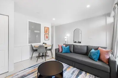 a living room with a couch and a table at Stylish 2BR Retreat by Queen West in Toronto