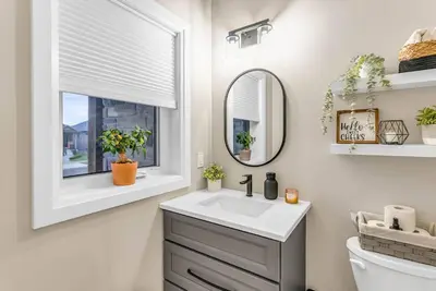a bathroom with a sink and a window at Cozy & Modern Home | EV Charger in Elmira