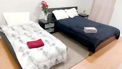 a bedroom with two beds and a red pillow at warm heart toronto in Toronto