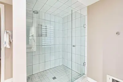 a shower with glass doors in a bathroom at 2BDR Condo Steps to Blue Mountain Village - 101 Cachet Crossing in Blue Mountains