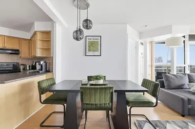 a kitchen and dining room with a table and chairs at Stylish 2br High-Rise - Sleeps 7 - YYZ in Mississauga