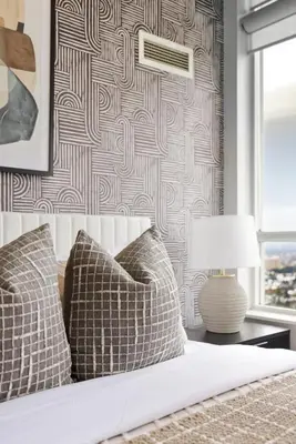 a bed with two pillows and a table with a lamp at Stylish 3br Condo - Parking - 65 TV in Mississauga