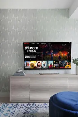 a living room with a tv on a wall at Designer 2BR - King Suite - Rare 2 Parking - YYZ in Mississauga
