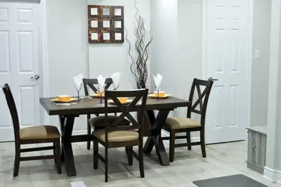 a dining room with a wooden table and chairs at Modern 4BR Lake Escape with Patio & BBQ Area in Kawartha Lakes