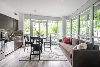 a living room with a couch and a table at Private Entrance 2 Bedroom Condo Downtown Toronto in Toronto