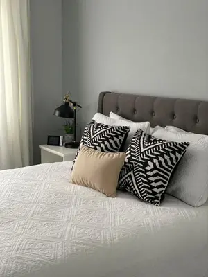 a bed with two pillows on top of it at Beautiful Home with Hot tub by YYZ, 20min to CN Tower in Toronto