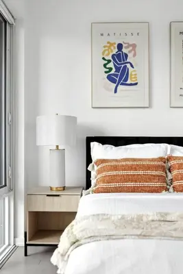 a bedroom with a bed and a table with a lamp at Chic Downtown Retreat with Private Patio in Toronto