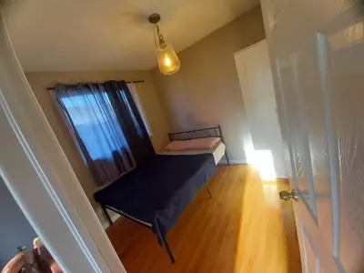 a small room with a bed and a window at Central Location New Year Stay- Free Parking & Fast Wifi in Kitchener