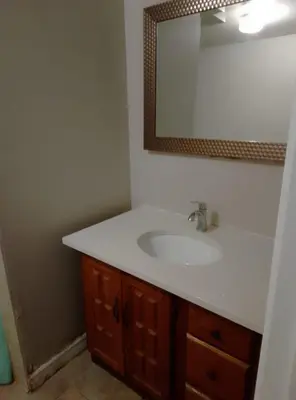 a bathroom with a sink and a mirror at Central Location New Year Stay- Free Parking & Fast Wifi in Kitchener