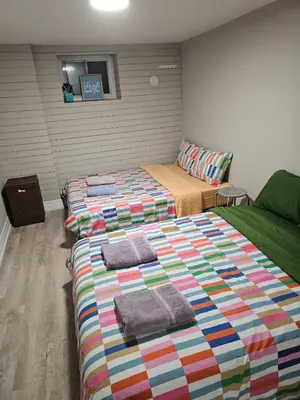 a bedroom with two beds with towels on them at Superb Guest House In Downtown-Self Checkin& Fast Wifi in Toronto