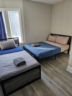 a room with two beds and a window at Superb Guest House In Downtown-Self Checkin& Fast Wifi in Toronto