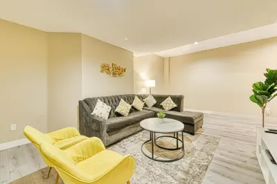 a living room with a couch and two chairs at The Urban Family Pad in Toronto