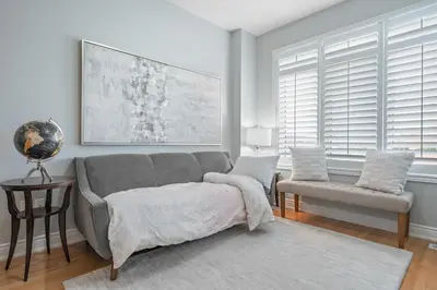 a living room with a couch and a chair at Spacious Toronto Home Near High Park and Yorkdale Mall in Toronto