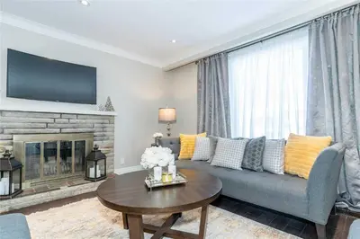 a living room with a couch and a fireplace at Beautiful 3 bed 2 bathroom home Toronto in Toronto