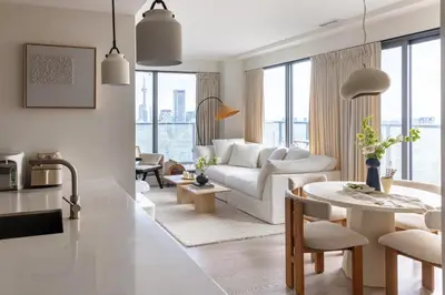 a living room with a white couch and a table at King Suites Toronto Downtown Soho District in Toronto