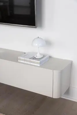 a white table with a lamp and books on it at King Suites Toronto Downtown Soho District in Toronto