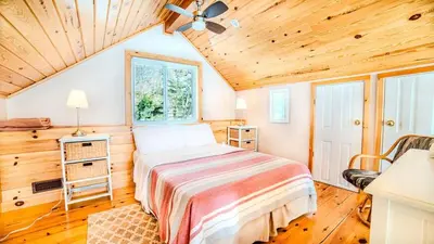 a bedroom with a bed and a ceiling fan at #90 Lakefront 3-bdrm Chalet in Muskoka in Port Carling