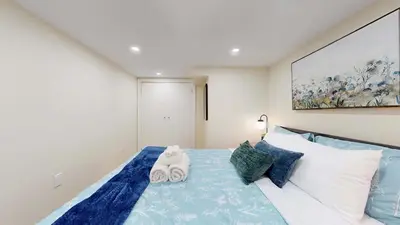 a bedroom with a bed with two towels on it at Cozy Basement Apartment for 4 - Near Cafes & Parks in Toronto