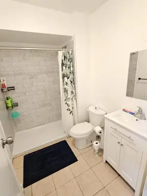 a white bathroom with a toilet and a sink at DOWNTOWN STAY-Free Wifi&Self Checkin in Toronto