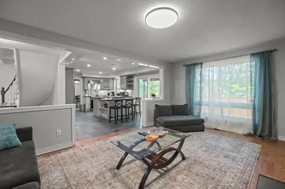 a living room with a couch and a table at 16 Guests Huge Spacious Home Near Ski Resorts in Barrie