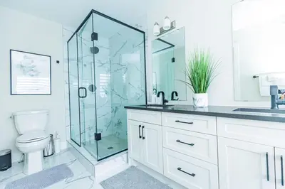 a bathroom with a glass shower and a toilet at Sauna, Hot Tub & Heated Pool Blue Mountain Getaway in Blue Mountains