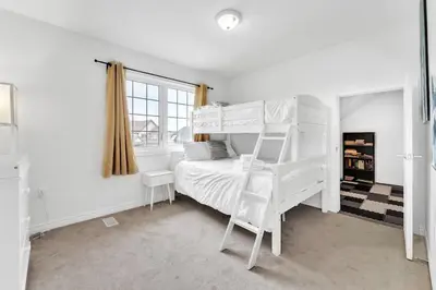 a bedroom with two bunk beds and a window at Spacious & New Prince Edward County Villa in Carrying Place