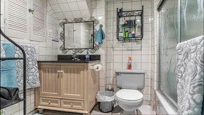 a bathroom with a toilet and a shower and a mirror at Cozy 2- bedroom private basement! in Mississauga