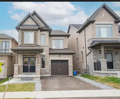 a large brick house with a garage at Oshawa Two Bedroom Private Suite in Oshawa