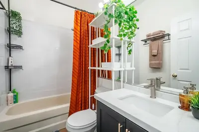 a bathroom with a sink and a toilet and a tub at The Artist Loft Trendy 2BR Condo with Parking in Toronto