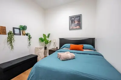 a bedroom with a bed with a stuffed animal on it at The Artist Loft Trendy 2BR Condo with Parking in Toronto