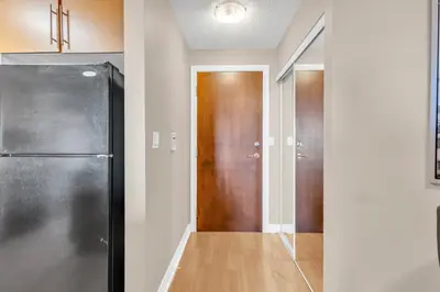 a hallway with a refrigerator and a door at 2 bedroom spacious apartment in Mississauga in Mississauga