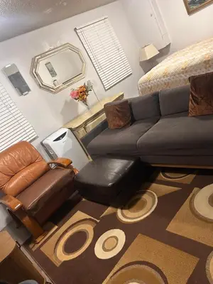 a living room with a couch and a chair at Pau-Rae's Cozy Spot - your home away from home! in Thornhill