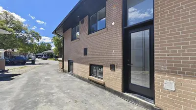 a brick building with a door on the side of it at Landen court in Mississauga