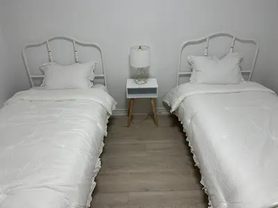 two beds sitting next to each other in a bedroom at K Niagara Guesthouse in Niagara Falls