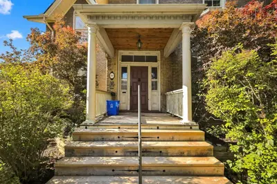 a house with stairs leading to the front door at Spacious 1 bed 1 bath Apt Close to Downtown and Beach in Cobourg