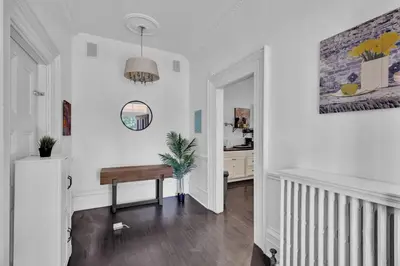 a white hallway with a bench and a mirror at Spacious 1 bed 1 bath Apt Close to Downtown and Beach in Cobourg