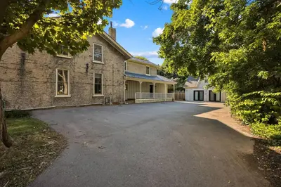 an empty driveway in front of a brick building at Spacious 1 bed 1 bath Apt Close to Downtown and Beach in Cobourg