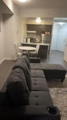 a living room with a couch and a table at Kanp version shared Apartments Toronto in Toronto